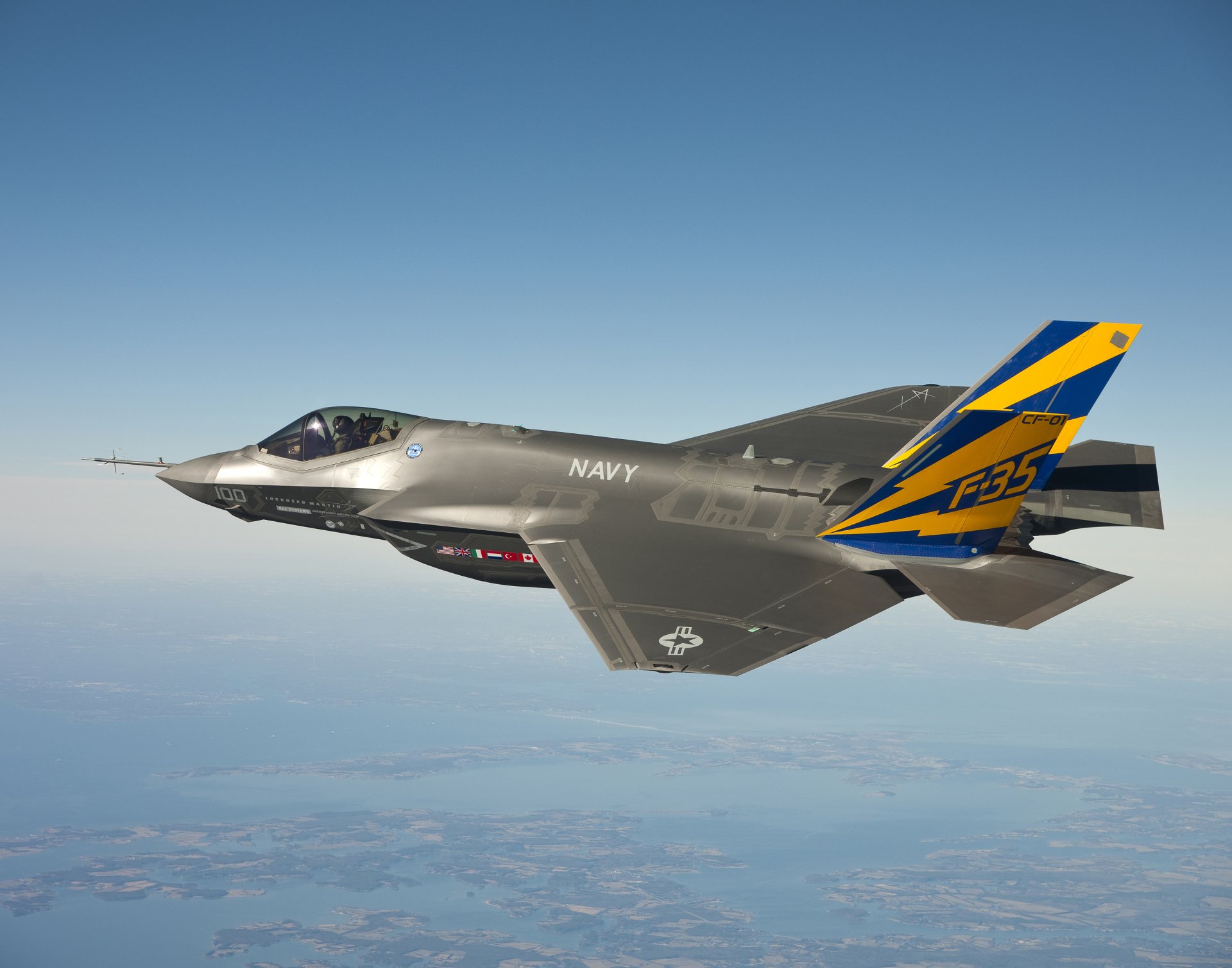 A Lockheed Martin F-35 Lightning II soars through the sky, showcasing its sleek design and military prowess, making a striking HD PC desktop wallpaper.