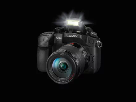 HD PC desktop wallpaper of a Panasonic Lumix camera, a man-made DSLR-style body with glass lens and popped flash against a black background.