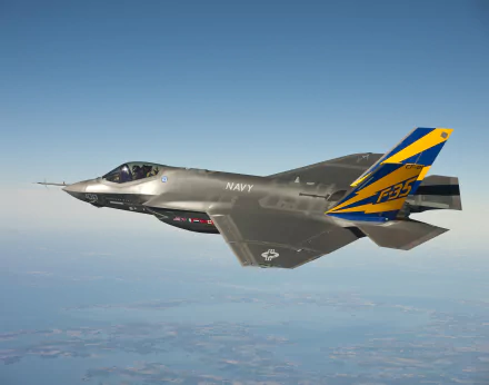 A Lockheed Martin F-35 Lightning II soars through the sky, showcasing its sleek design and military prowess, making a striking HD PC desktop wallpaper.