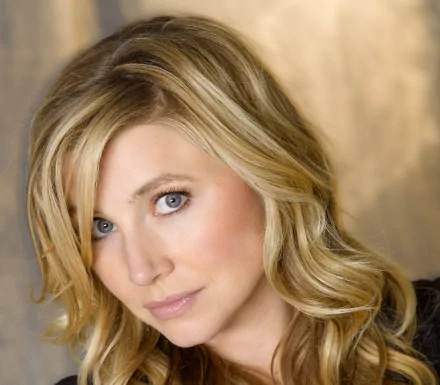 HD desktop wallpaper featuring celebrity Sarah Chalke, showcasing her captivating expression and soft, blonde waves against a warm background.