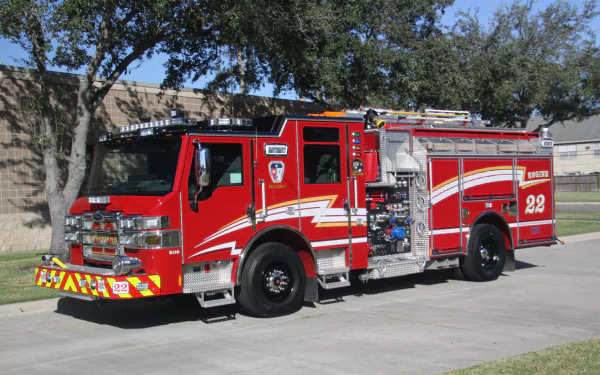A bright red Pierce fire truck parked on a concrete path under trees, captured in sharp detail as a 4K Ultra HD PC desktop wallpaper and background.