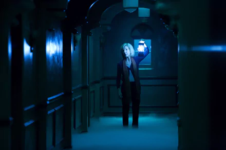 Lin Shaye in a dark, eerie hallway holding a lantern from the movie Insidious: Chapter 3, shown in a 4K Ultra HD PC desktop wallpaper and background.