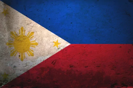 Flag of the Philippines displayed as a textured HD desktop wallpaper, featuring the country's blue, red, and white colors along with the sun and stars emblem.