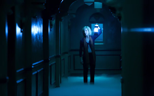 Lin Shaye in a dark, eerie hallway holding a lantern from the movie Insidious: Chapter 3, shown in a 4K Ultra HD PC desktop wallpaper and background.