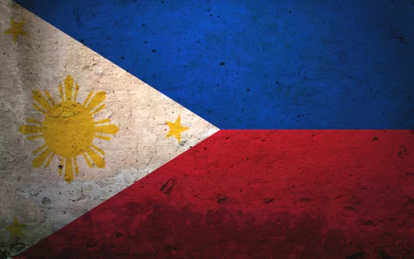 Flag of the Philippines displayed as a textured HD desktop wallpaper, featuring the country's blue, red, and white colors along with the sun and stars emblem.
