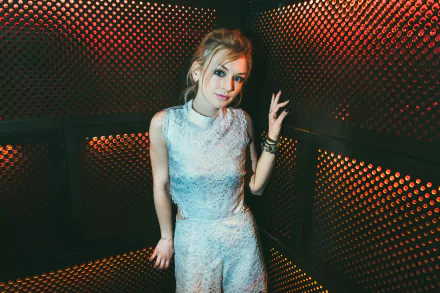 HD desktop wallpaper featuring American singer and actress Emily Kinney posing against a textured dark background with orange lighting accents.