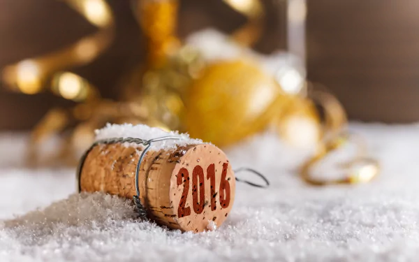Holiday New Year 2016 4K Ultra HD PC desktop wallpaper: close-up of a champagne cork stamped 2016 in snow, with golden baubles and curled ribbon blurred behind.
