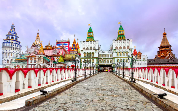 Colorful Russian architecture at the Moscow Kremlin, showcasing intricate rooftops and a stone pathway under a pastel sky. A stunning 4K Ultra HD wallpaper of this iconic cityscape.