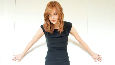 A stunning HD desktop wallpaper featuring Emma Stone, showcasing her confident pose and signature style against a minimalist background.