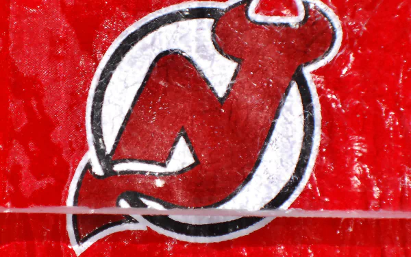 HD desktop wallpaper featuring the New Jersey Devils logo with a textured red background, showcasing the sports team's iconic emblem.