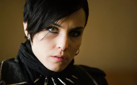 Moody close-up portrait of a short-haired woman with a nose ring and spiked collar, movie-themed 2K Quad HD PC desktop wallpaper/background.