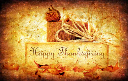 HD Thanksgiving-themed desktop wallpaper featuring a rustic card with Happy Thanksgiving text, autumn leaves, and seasonal decorations creating a warm holiday atmosphere.