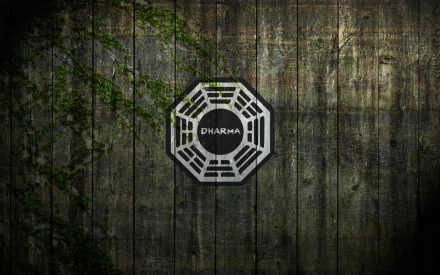 A dark HD wallpaper featuring the Dharma Initiative logo from the TV show Lost, set against a textured wooden background with hints of greenery.