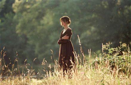 Keira Knightley as Elizabeth Bennet in a serene outdoor scene from the movie Pride & Prejudice, displayed in 4K Ultra HD for PC desktop wallpaper.