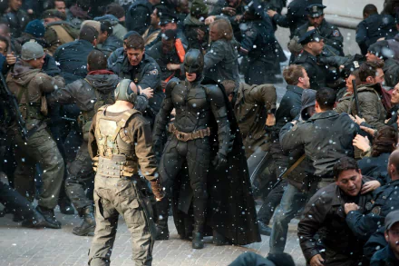HD PC desktop wallpaper: Batman and Bane (DC Comics) clashing in a snowy street brawl — scene from The Dark Knight Rises movie.