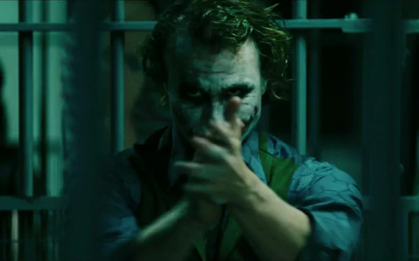 Heath Ledger as the Joker in *The Dark Knight*, captured in this HD desktop wallpaper. The image showcases his iconic, menacing expression in a dark, atmospheric setting.