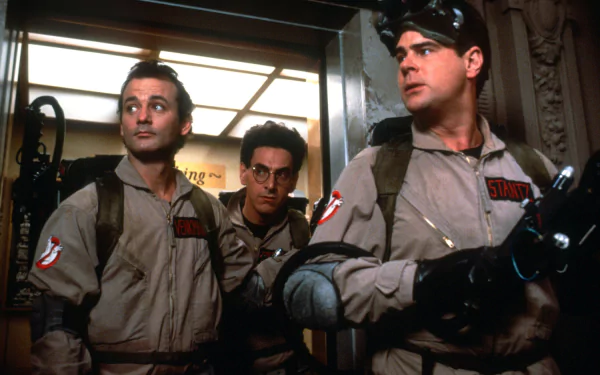 A vibrant HD wallpaper featuring Dan Aykroyd, Bill Murray, and Harold Ramis in iconic Ghostbusters gear, ready for an adventure in an elevator setting.