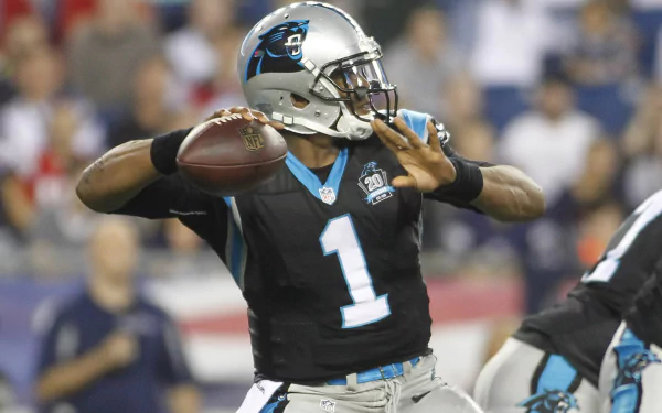 HD PC desktop wallpaper showing a Carolina Panthers player (#1) in black uniform throwing a football during a live sports game background.