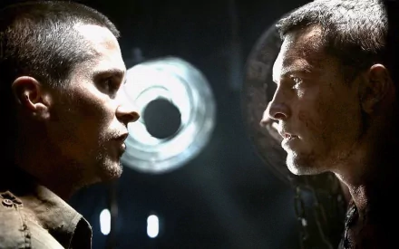 A dramatic face-off between two characters from The Terminator, set against a dark background with striking lighting. This HD desktop wallpaper captures the tension of the iconic film.