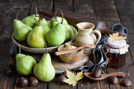HD still life desktop wallpaper featuring fresh green pears, honey jar, wooden utensils, and autumn leaves on a rustic wooden table, evoking the fall season.