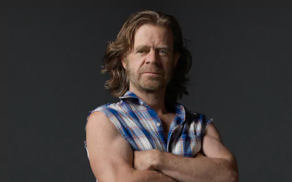 A character from the TV show Shameless, posed confidently with arms crossed, showcasing a rugged look in a plaid shirt. This image serves as an HD desktop wallpaper.