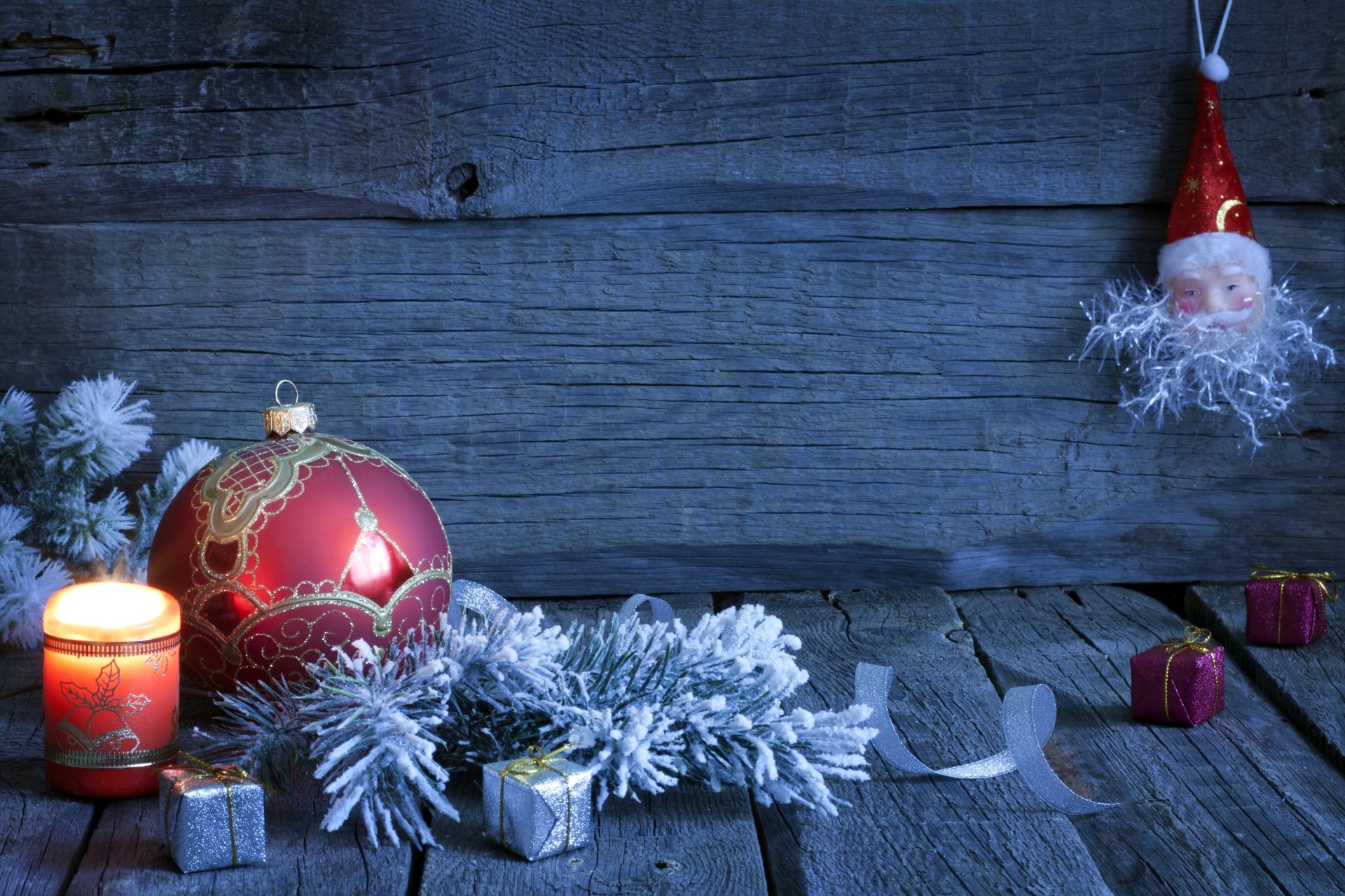 A festive scene featuring a glowing candle, ornate Christmas ornament, and holiday decorations, set against a rustic wood background, capturing the essence of Christmas cheer.