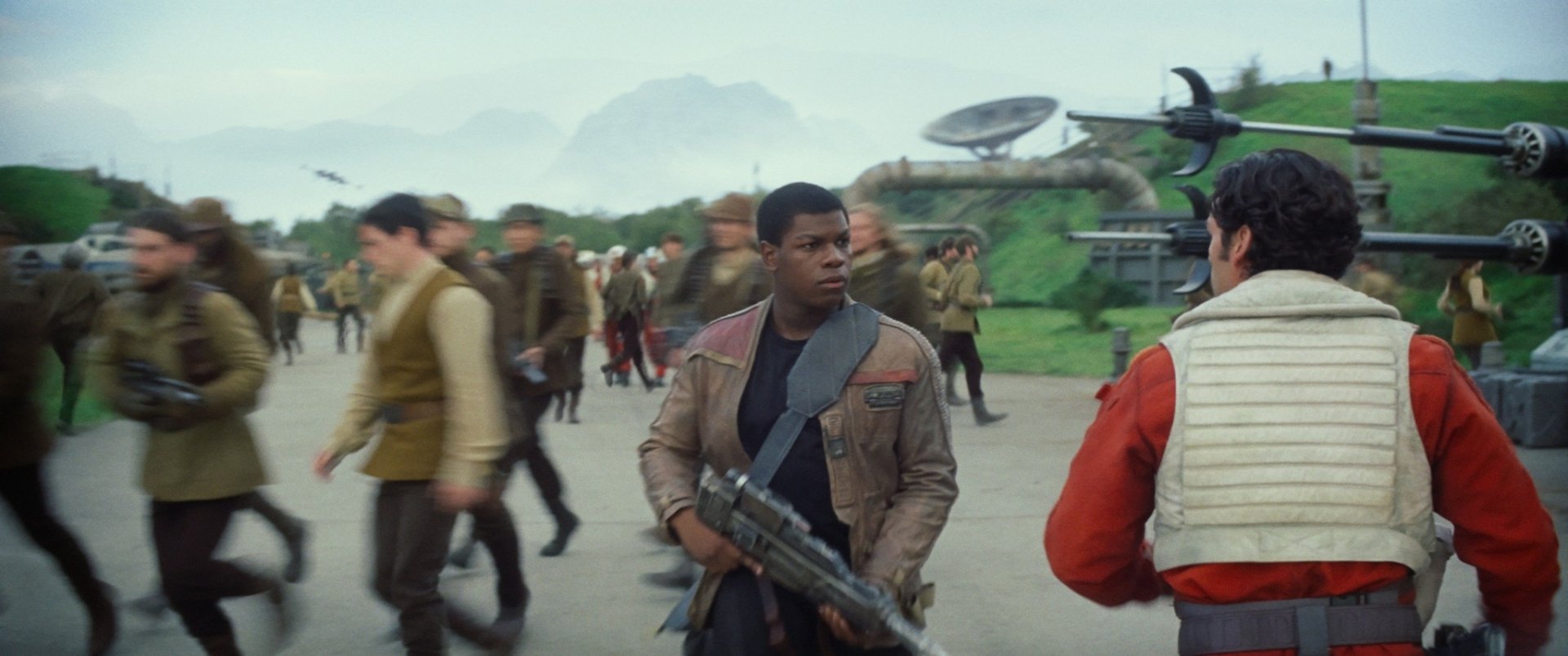 HD PC wallpaper featuring Finn, portrayed by John Boyega, from Star Wars Episode VII: The Force Awakens, amidst a busy Rebel base scene.