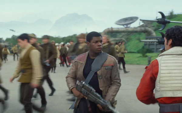 HD PC wallpaper featuring Finn, portrayed by John Boyega, from Star Wars Episode VII: The Force Awakens, amidst a busy Rebel base scene.