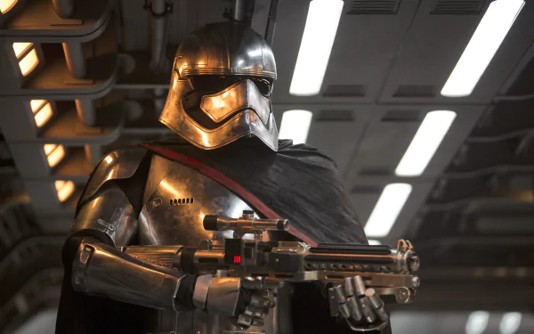 Captain Phasma stands poised with a weapon in hand, showcasing her distinctive silver armor and dark cape in a scene from Star Wars Episode VII: The Force Awakens. 4K Ultra HD quality.