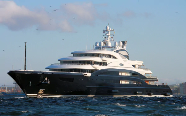 Sleek motor yacht (vehicle, yacht) cutting through blue sea under a clear sky — 4K Ultra HD PC desktop wallpaper and background.