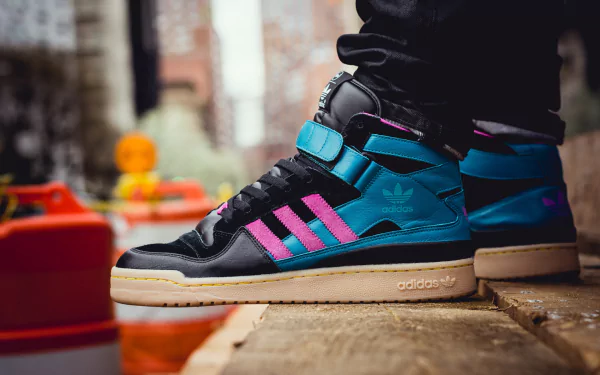 Close-up shot of a man-made Adidas sneaker with blue and pink accents, featured as an HD PC desktop wallpaper and background.