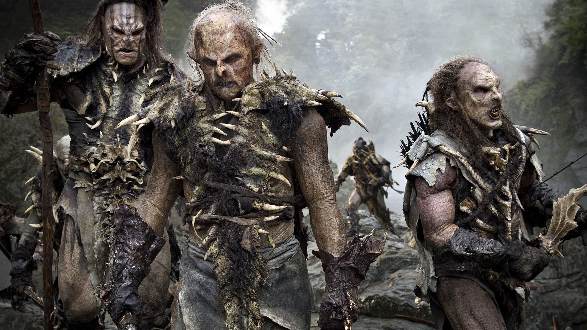 HD PC desktop wallpaper from the movie The Hobbit: The Desolation of Smaug featuring a group of menacing orcs in rugged armor.