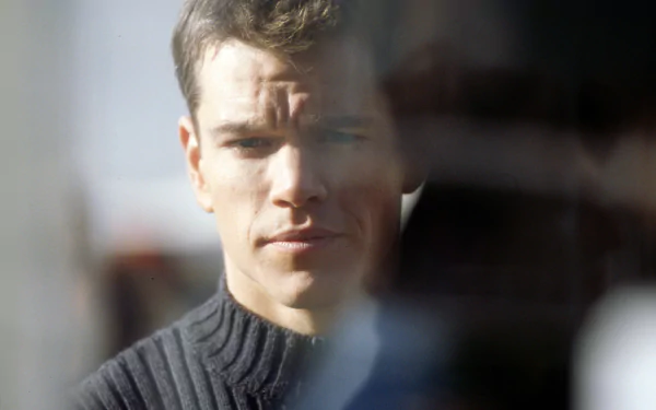 HD PC desktop wallpaper featuring a close-up of Matt Damon in a reflective moment from the movie The Bourne Identity.