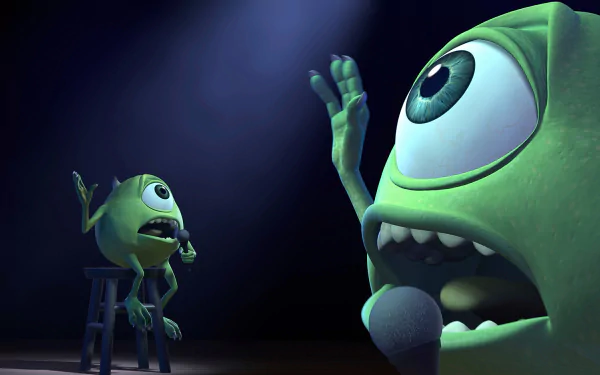 Two green monsters from *Monsters, Inc.* perform comically on stage, one speaking into a microphone while the other listens attentively, creating a lively atmosphere. HD wallpaper.