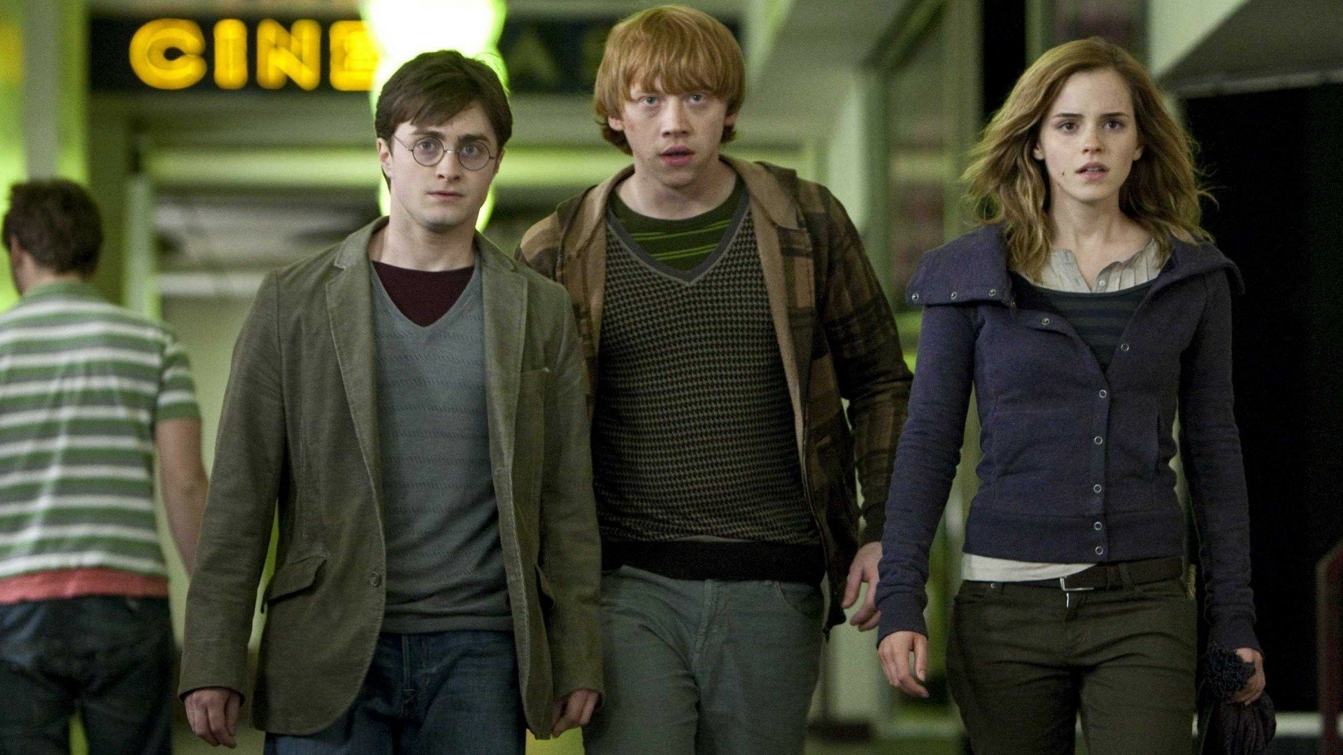 Harry Potter, Ron Weasley, and Hermione Granger walk together in a scene from Harry Potter and the Deathly Hallows: Part 1, featuring key characters from the beloved movie series.