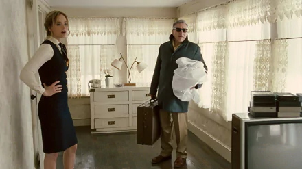 HD desktop wallpaper: still from a 2015 movie — a woman in a dress stands hands on hips as an older man in sunglasses carries a suitcase in a sunlit retro kitchen.