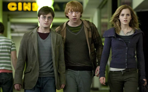 Harry Potter, Ron Weasley, and Hermione Granger walk together in a scene from Harry Potter and the Deathly Hallows: Part 1, featuring key characters from the beloved movie series.