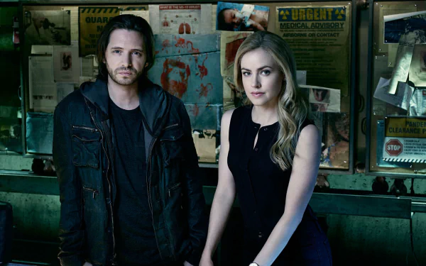 HD PC desktop wallpaper: promotional image from the TV show 12 Monkeys — two characters stand in a dim, cluttered investigation room with a bulletin board background.