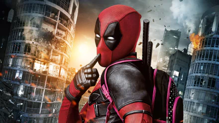 HD desktop wallpaper of Deadpool standing amidst exploding skyscrapers with a thoughtful pose and backpack, from the movie Deadpool.