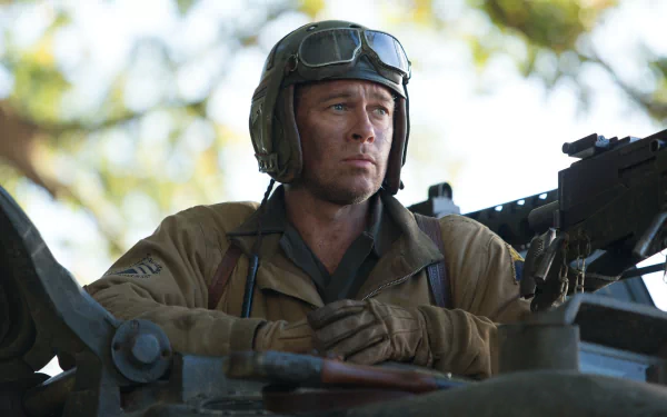 A high-definition desktop wallpaper featuring Brad Pitt in a scene from the movie Fury, showcasing his serious expression while seated in a tank.