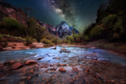Night sky with the Milky Way over a rocky river and cliffs in Zion National Park, Utah, showcasing stunning mountain nature at star-filled night.