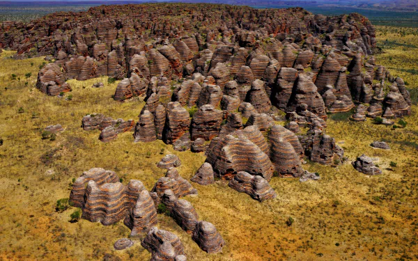 A stunning HD landscape of layered rock formations at Purnululu National Park, Australia, showcasing unique natural beauty in a vibrant, expansive wilderness.