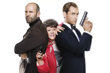 HD PC desktop wallpaper featuring Jude Law, Melissa McCarthy, and Jason Statham from the 2015 movie Spy, each holding a gun against a white background.