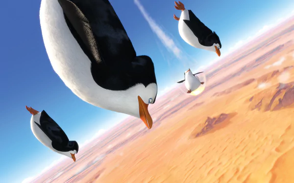 HD PC desktop wallpaper featuring animated penguins from the movie Penguins of Madagascar soaring above a desert landscape.