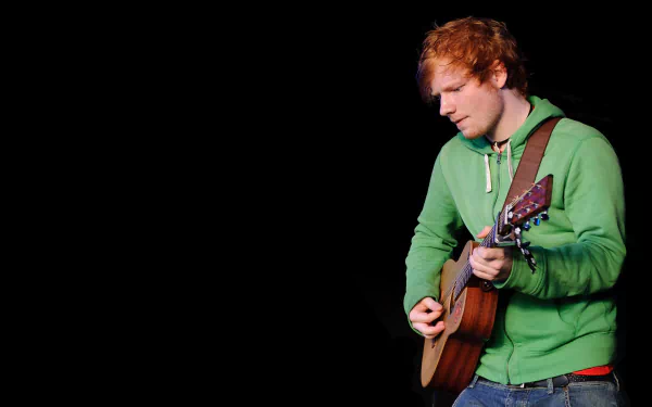 HD PC desktop wallpaper featuring English singer Ed Sheeran playing guitar against a black background.
