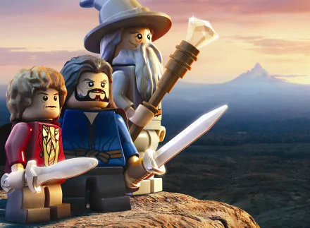 Lego figures of Gandalf, Bilbo Baggins, and another character stand together, wielding swords against a scenic background from The Lord of the Rings. HD desktop wallpaper.