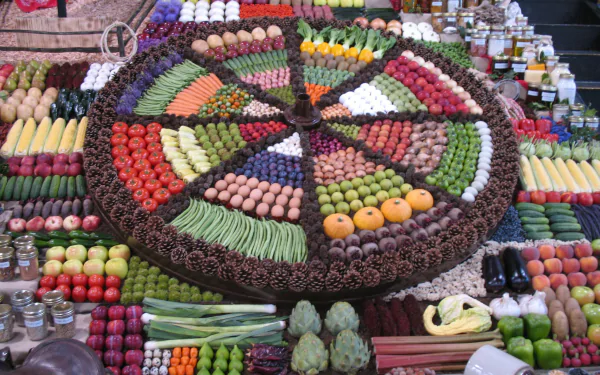 HD PC desktop wallpaper showcasing a vibrant, circular arrangement of fresh fruits and vegetables displayed at a market stall.