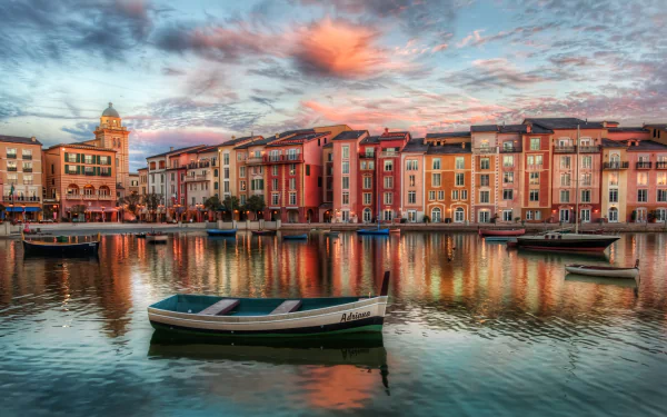 A serene HDR waterfront scene in Orlando, Florida, showcasing colorful buildings reflecting in the water, with a small boat anchored in the foreground at sunset.