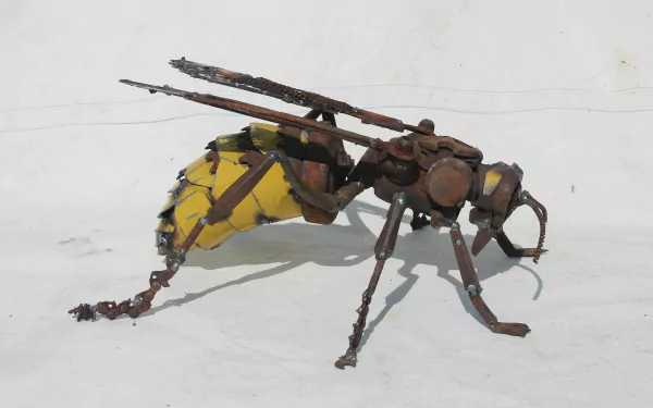 HD PC desktop wallpaper of a man-made scrap metal wasp sculpture with a yellow-painted abdomen on a white background.