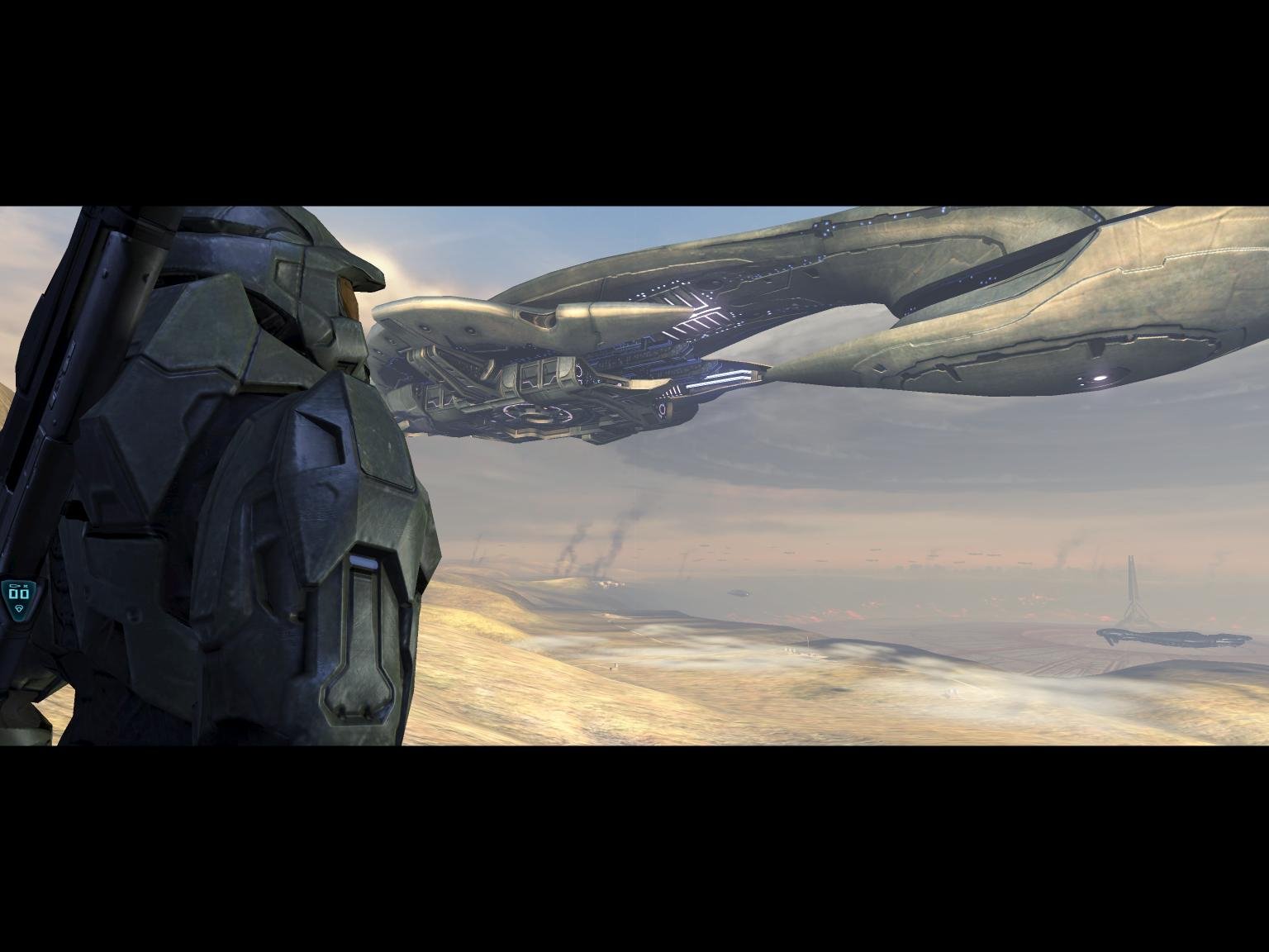 HD PC desktop wallpaper featuring a Halo video game scene with a soldier in armor overlooking a vast desert landscape and a massive alien spaceship overhead.